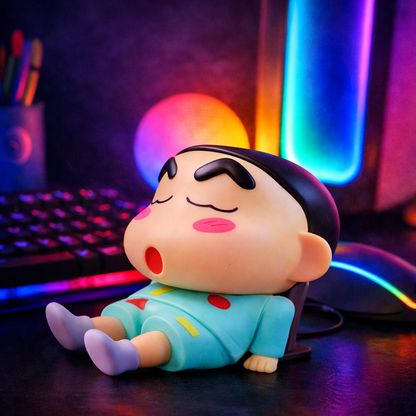 Cute cartoon figurine mobile phone stand placed on desk for watching videos and video calls